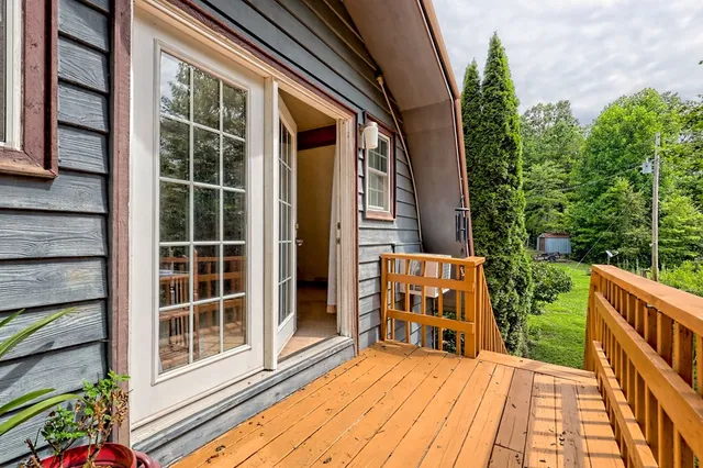 a view of a hallway view with wooden floor and windows
