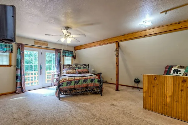 a kitchen with stainless steel appliances kitchen island granite countertop a table chairs in it and wooden floors