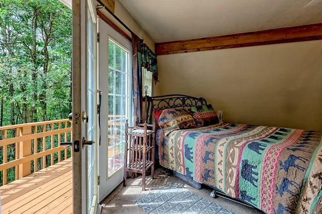a view of a patio with table and chairs barbeque potted plants and large tree