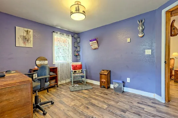 a kitchen with stainless steel appliances granite countertop a stove top oven a sink dishwasher a dining table and chairs with wooden floor