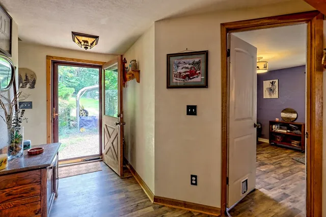 a kitchen with stainless steel appliances kitchen island granite countertop a stove refrigerator and cabinets