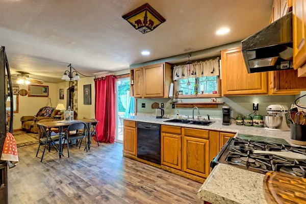 a view of a hallway with wooden floor and windows