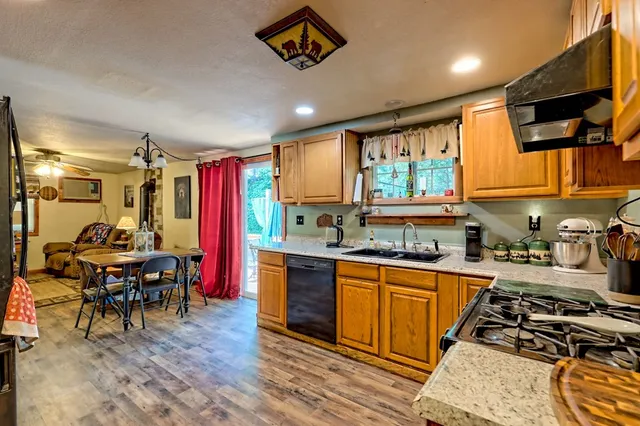 a view of a hallway with wooden floor and windows