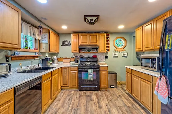 a view of small house with wooden stairs and floor to ceiling window