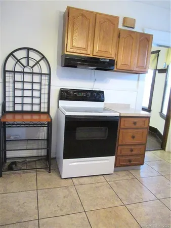 a kitchen with a stove and a cabinet