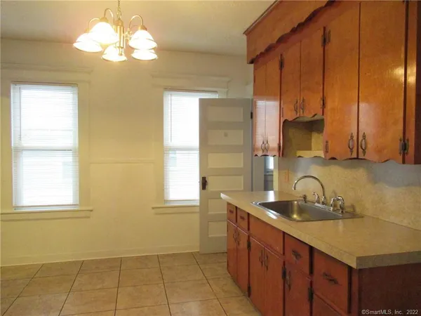 a kitchen with a sink cabinets and window
