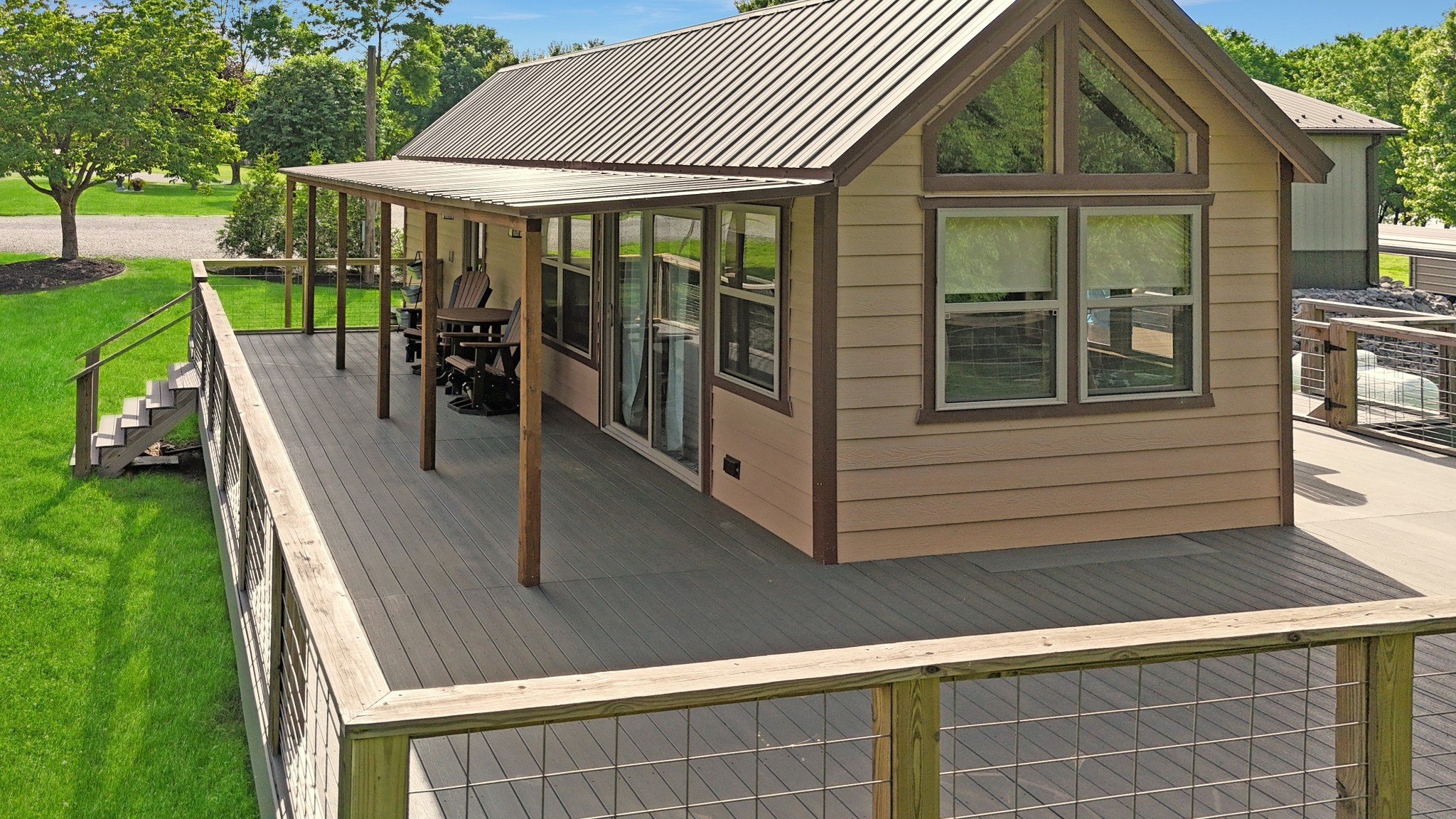 836 Prizer Point Road Cadiz, KY 42211 - Photo 3 of 82 a view of a patio with table and chairs under an umbrella with a small yard