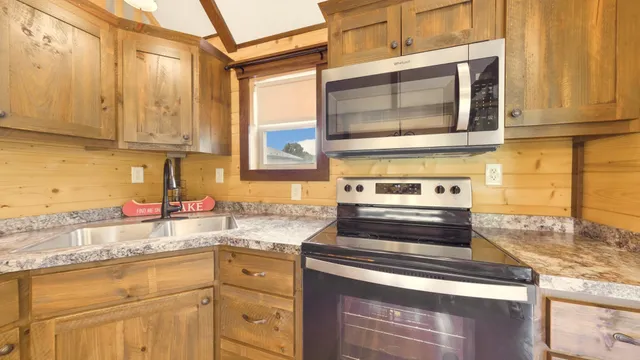 a roof deck with table and chairs a barbeque with wooden floor and fence