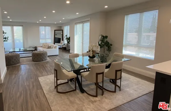 a dining room with furniture and wooden floor
