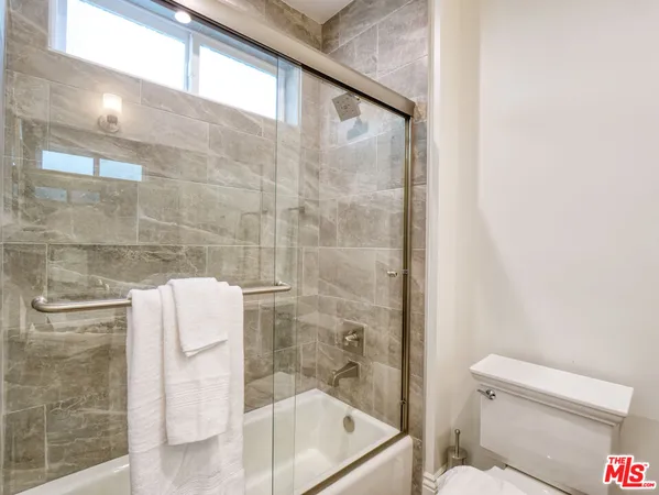 a bathroom with a toilet and shower