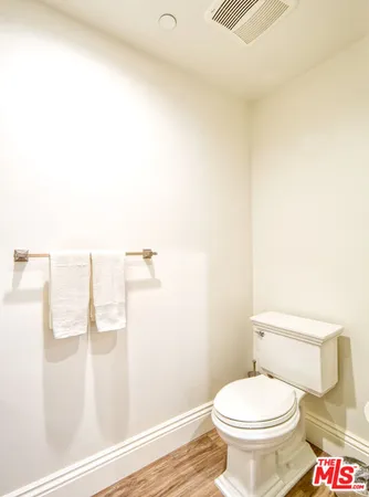 a white toilet sitting next to a bathroom sink