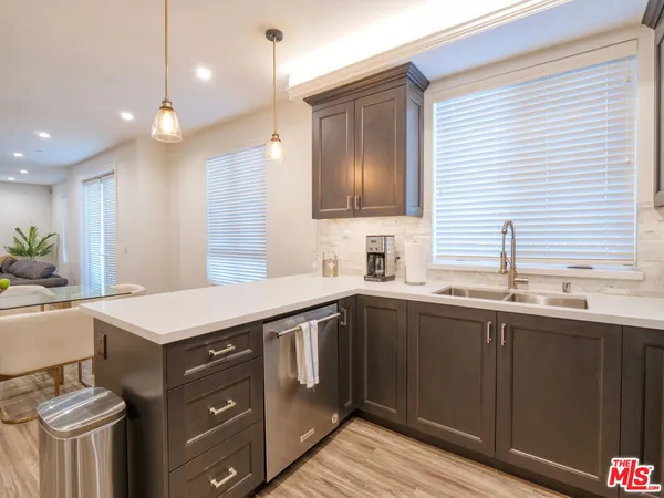 a kitchen that has a sink and a stove in it