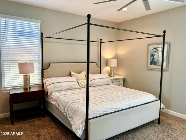 a bedroom with a bed and a window