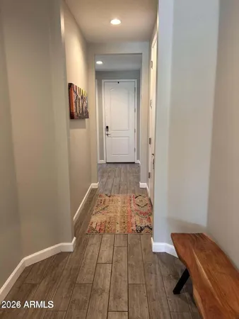 a view of a room with wooden floor and bathroom