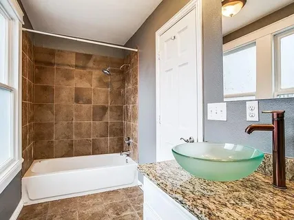 a bathroom with a tub and a sink