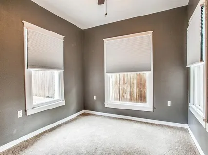 an empty room with windows and closet