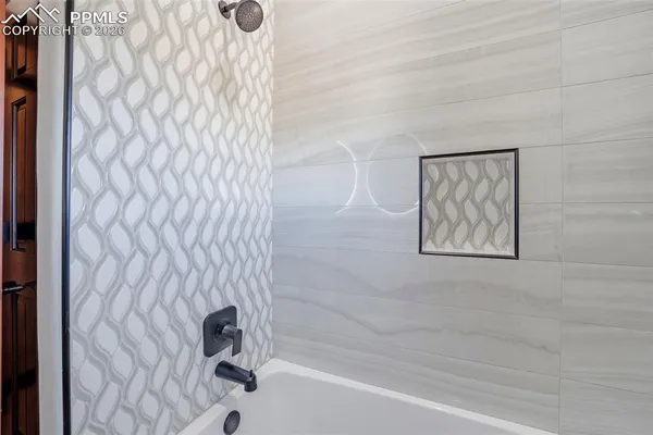 a bathroom with a bathtub and shower