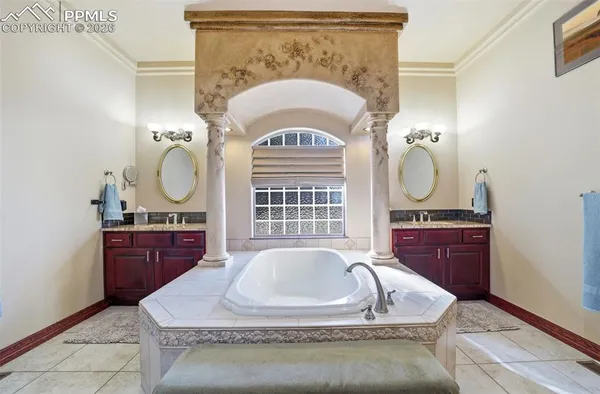 a bathroom with a tub sink and mirror