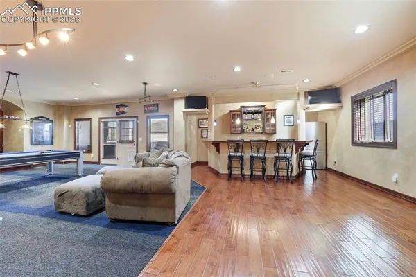 a dining area with furniture and wooden floor
