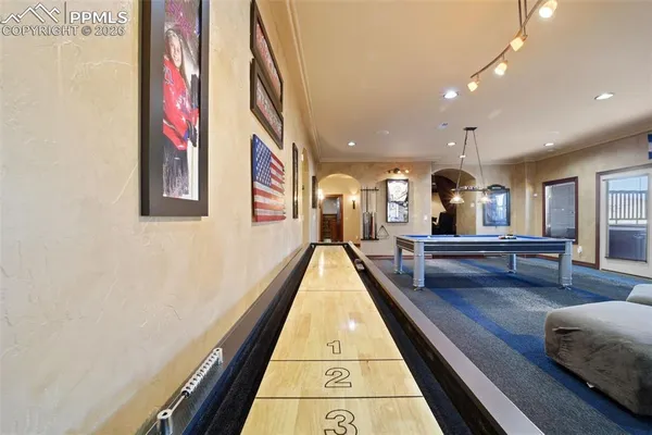 a room with pool table and windows
