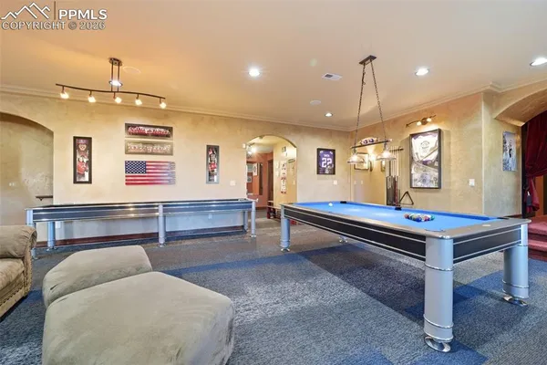 a room with pool table and windows