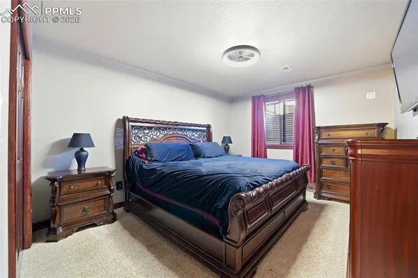a living room with furniture a large window and a flat screen tv