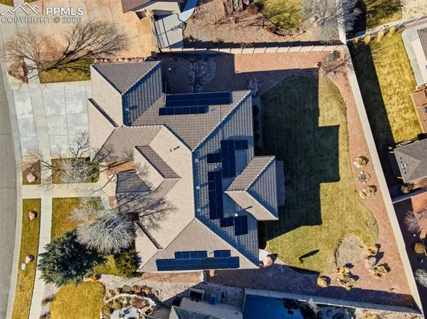 a aerial view of a house with swimming pool and a yard