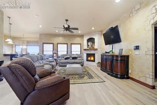 a living room with furniture a flat screen tv and kitchen view