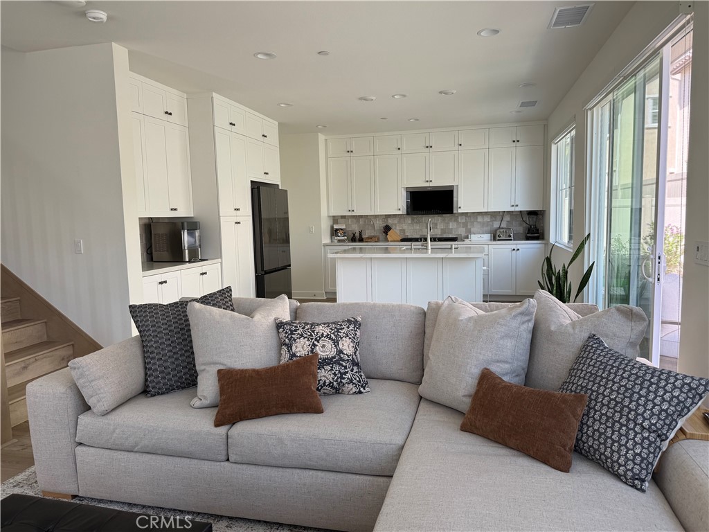 541 Jasper Street Rancho Mission Viejo, CA 92694 - Photo 4 of 20 a living room with furniture fireplace and a window