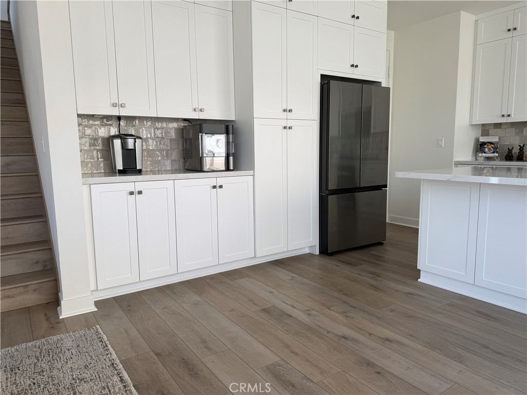 541 Jasper Street Rancho Mission Viejo, CA 92694 - Photo 5 of 20 a kitchen with stainless steel appliances granite countertop a refrigerator sink and white cabinets