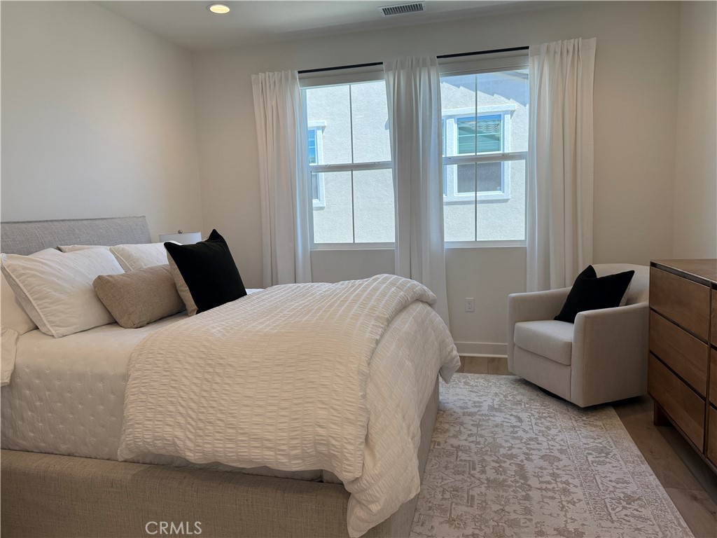 541 Jasper Street Rancho Mission Viejo, CA 92694 - Photo 6 of 20 a bedroom with bed couch and window