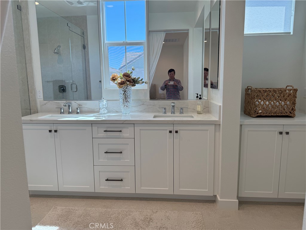 541 Jasper Street Rancho Mission Viejo, CA 92694 - Photo 7 of 20 a bathroom with a double vanity sink and a mirror