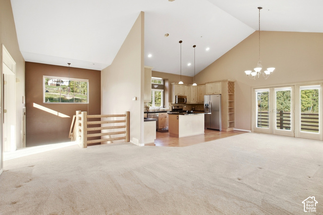 Vaulted ceiling, recessed lighting, wood-finish flooring, stainless steel appliances, and French doors