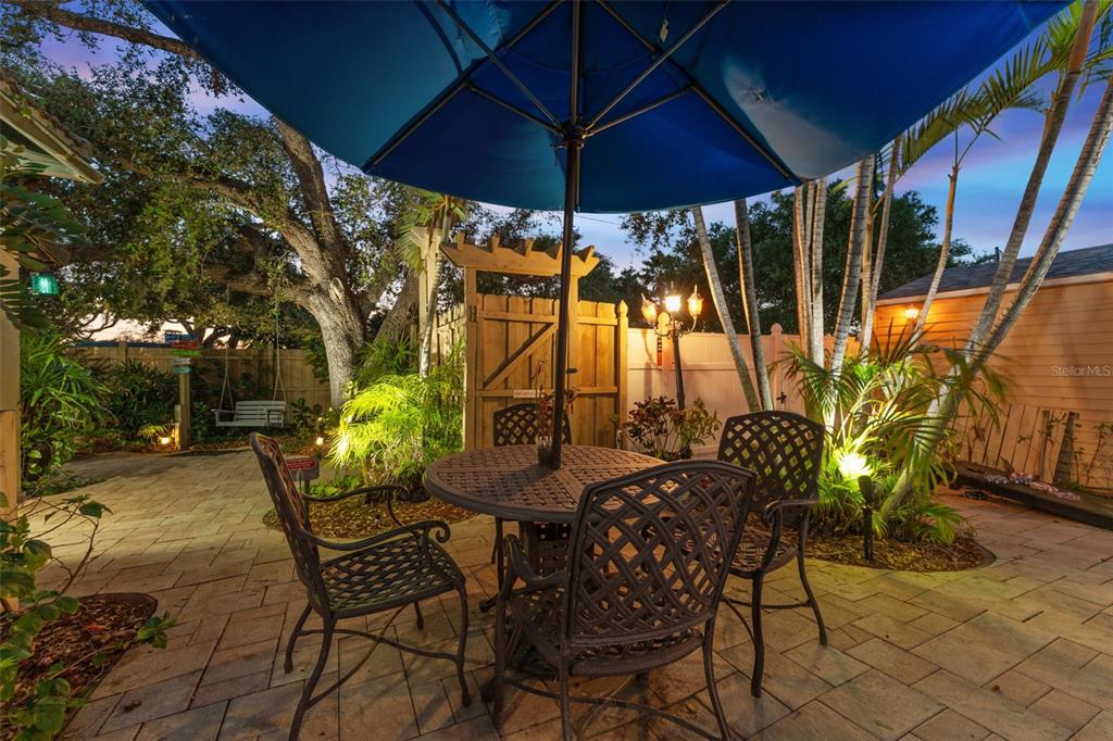 1500 Maple Street Clearwater, FL 33755 - Photo 11 of 96 a view of patio with table and chairs under an umbrella