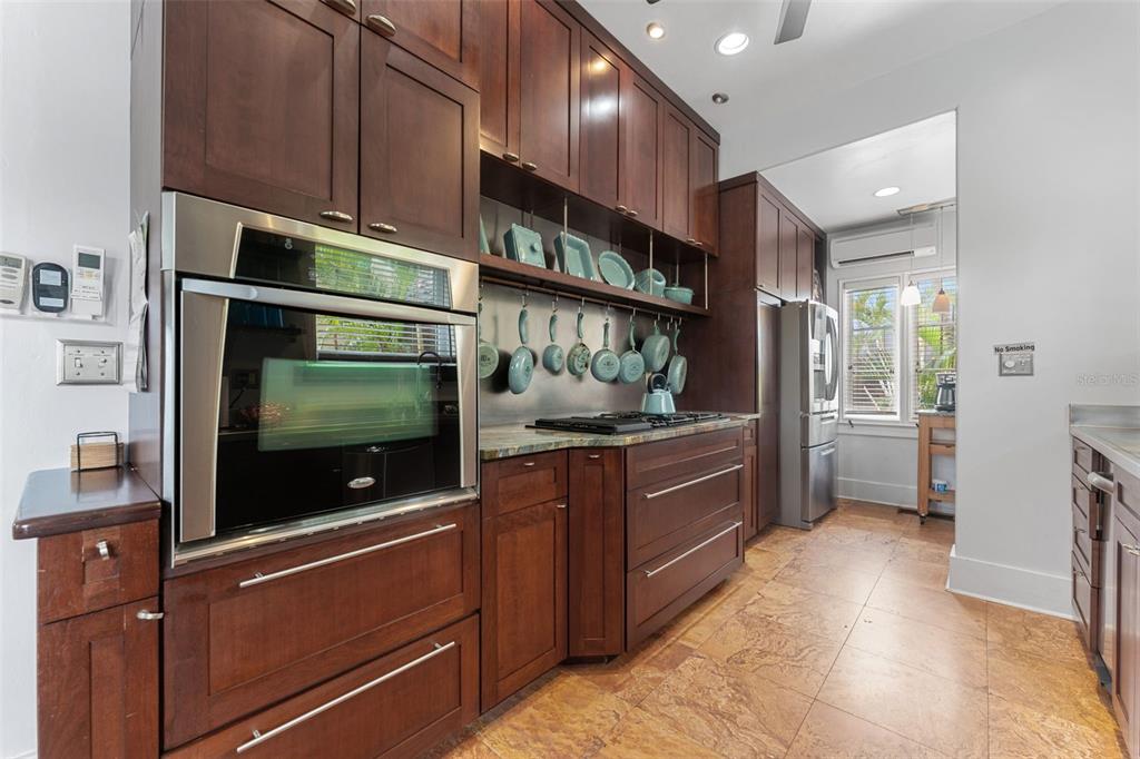 1500 Maple Street Clearwater, FL 33755 - Photo 21 of 96 a kitchen with stainless steel appliances kitchen island granite countertop a refrigerator and a stove top oven