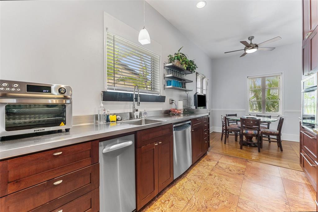 1500 Maple Street Clearwater, FL 33755 - Photo 24 of 96 a kitchen with stainless steel appliances a stove a sink a dining table and chairs