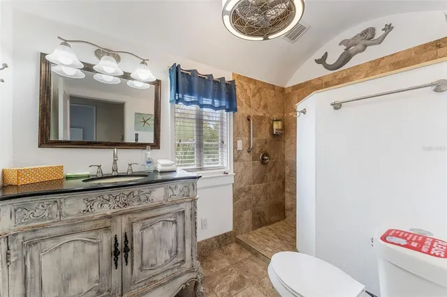 a kitchen with stainless steel appliances white cabinets and a refrigerator