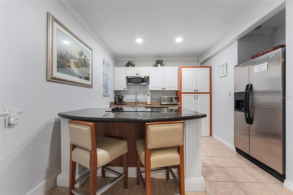 1500 Maple Street Clearwater, FL 33755 - Photo 75 of 96 a kitchen with stainless steel appliances granite countertop a sink refrigerator and microwave