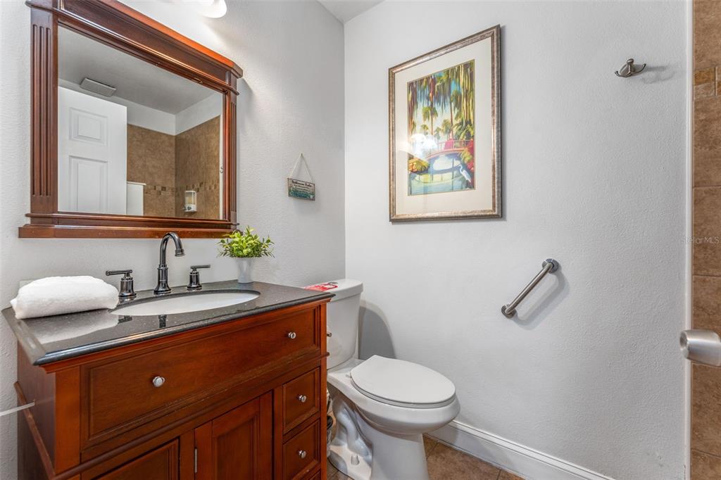 1500 Maple Street Clearwater, FL 33755 - Photo 81 of 96 a bathroom with a toilet a sink and mirror