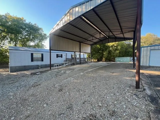 a view of a backyard with large tree