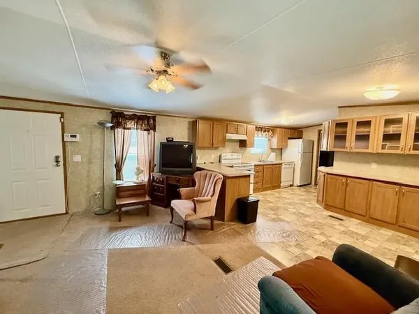 a kitchen with stainless steel appliances granite countertop a stove a sink dishwasher and a refrigerator