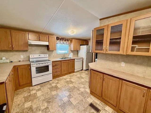 an empty room with fan and entrance