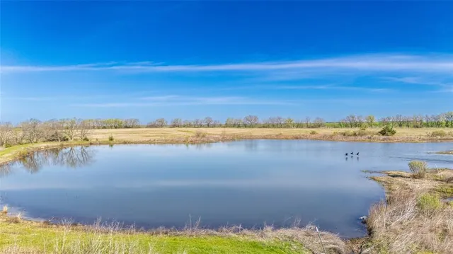 a view of a lake with houses in the background