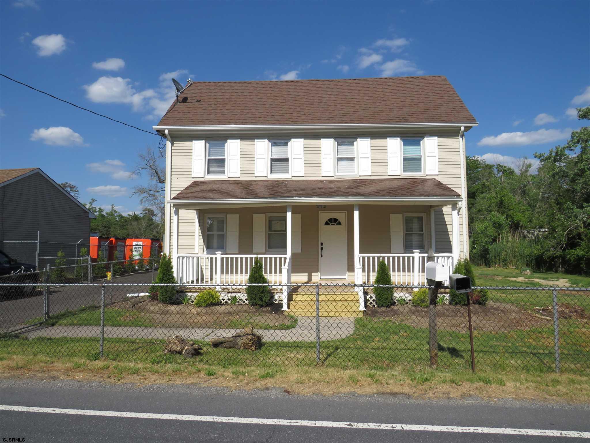 a front view of a house with a yard garden