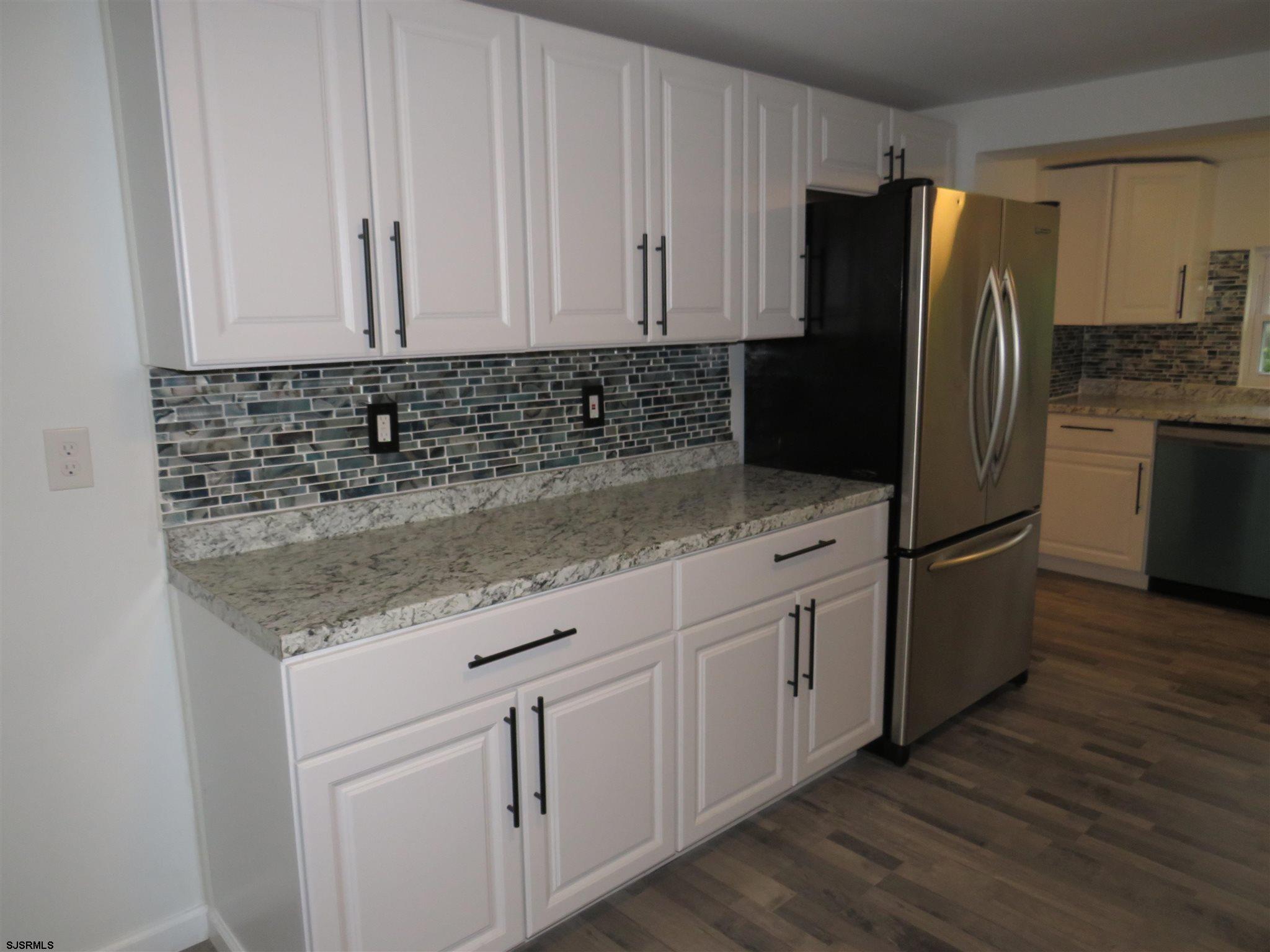 1702 Somers Point Road Egg Harbor Township, NJ 08234 - Photo 12 of 25 a kitchen with granite countertop white cabinets white stainless steel appliances and granite counter tops