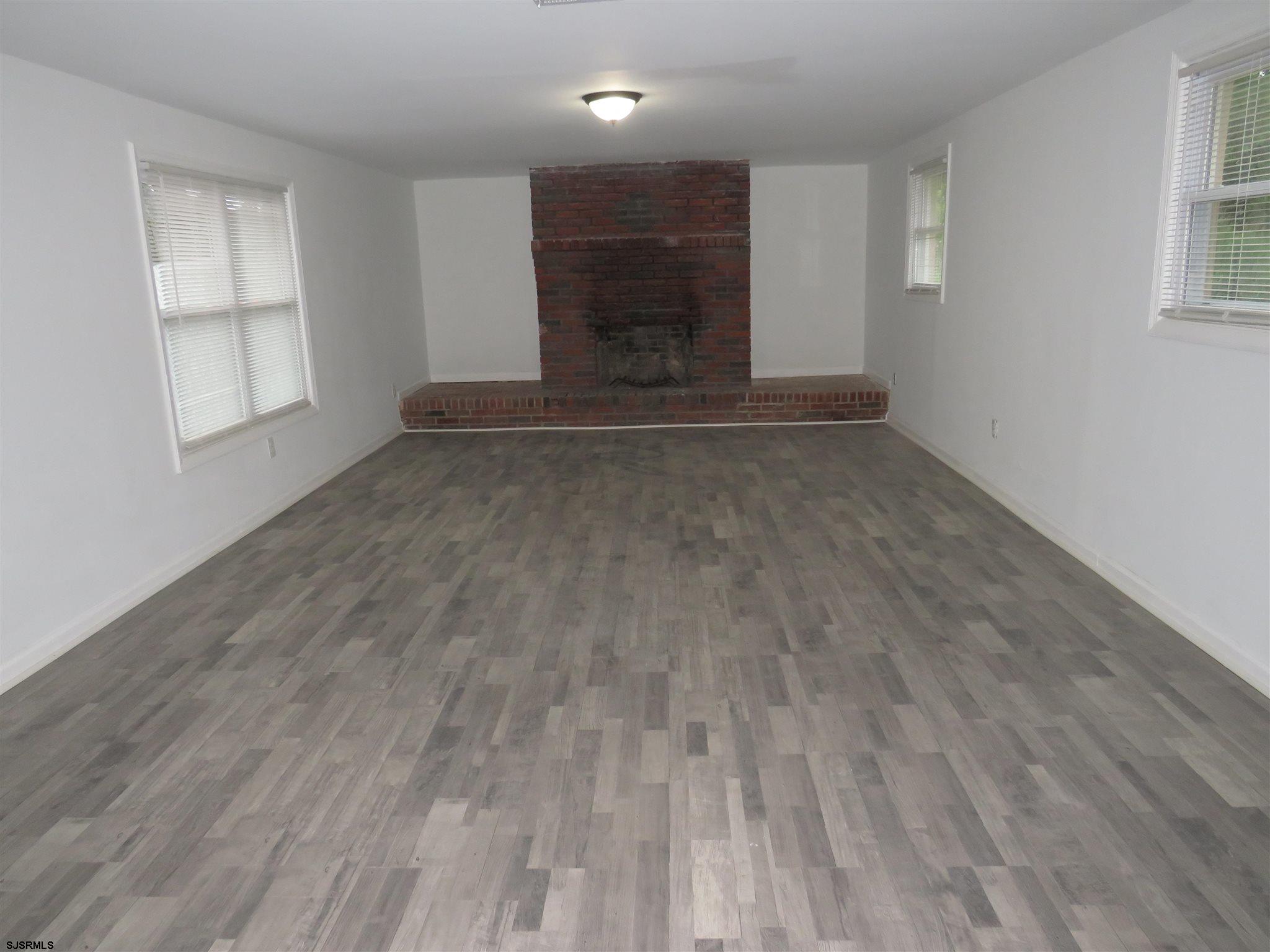 1702 Somers Point Road Egg Harbor Township, NJ 08234 - Photo 14 of 25 wooden floor in an empty room with a window