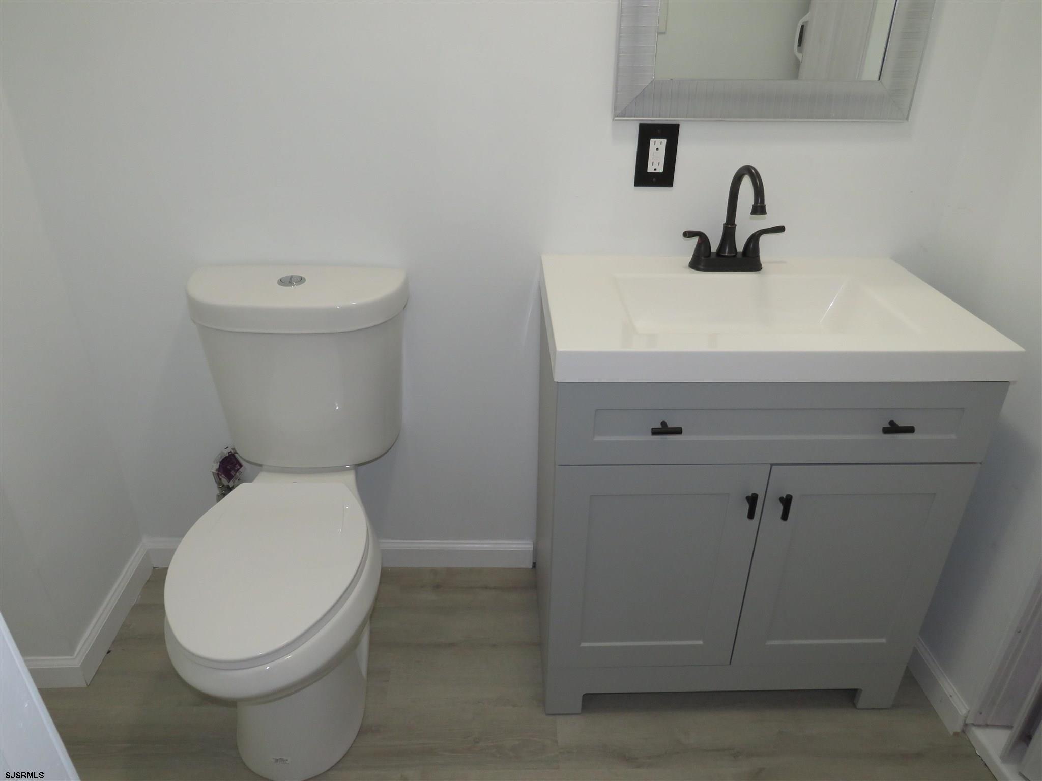 1702 Somers Point Road Egg Harbor Township, NJ 08234 - Photo 15 of 25 a white toilet sitting next to a bathroom sink