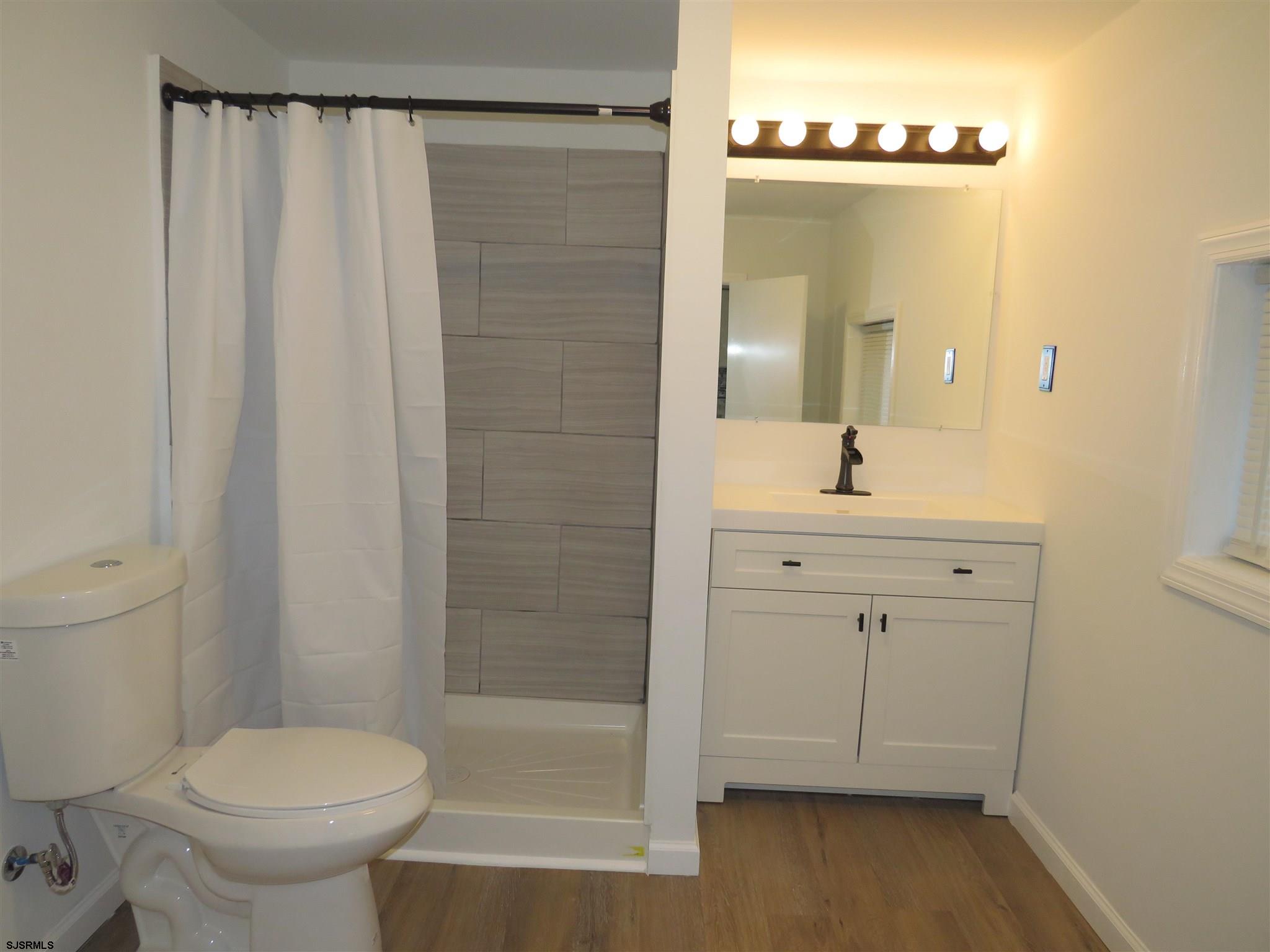 1702 Somers Point Road Egg Harbor Township, NJ 08234 - Photo 16 of 25 a bathroom with a sink a toilet and shower