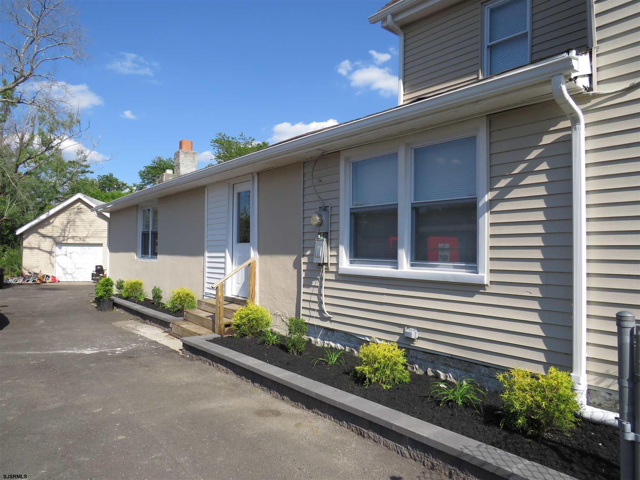 1702 Somers Point Road Egg Harbor Township, NJ 08234 - Photo 8 of 25 a front view of a house with a yard and potted plants
