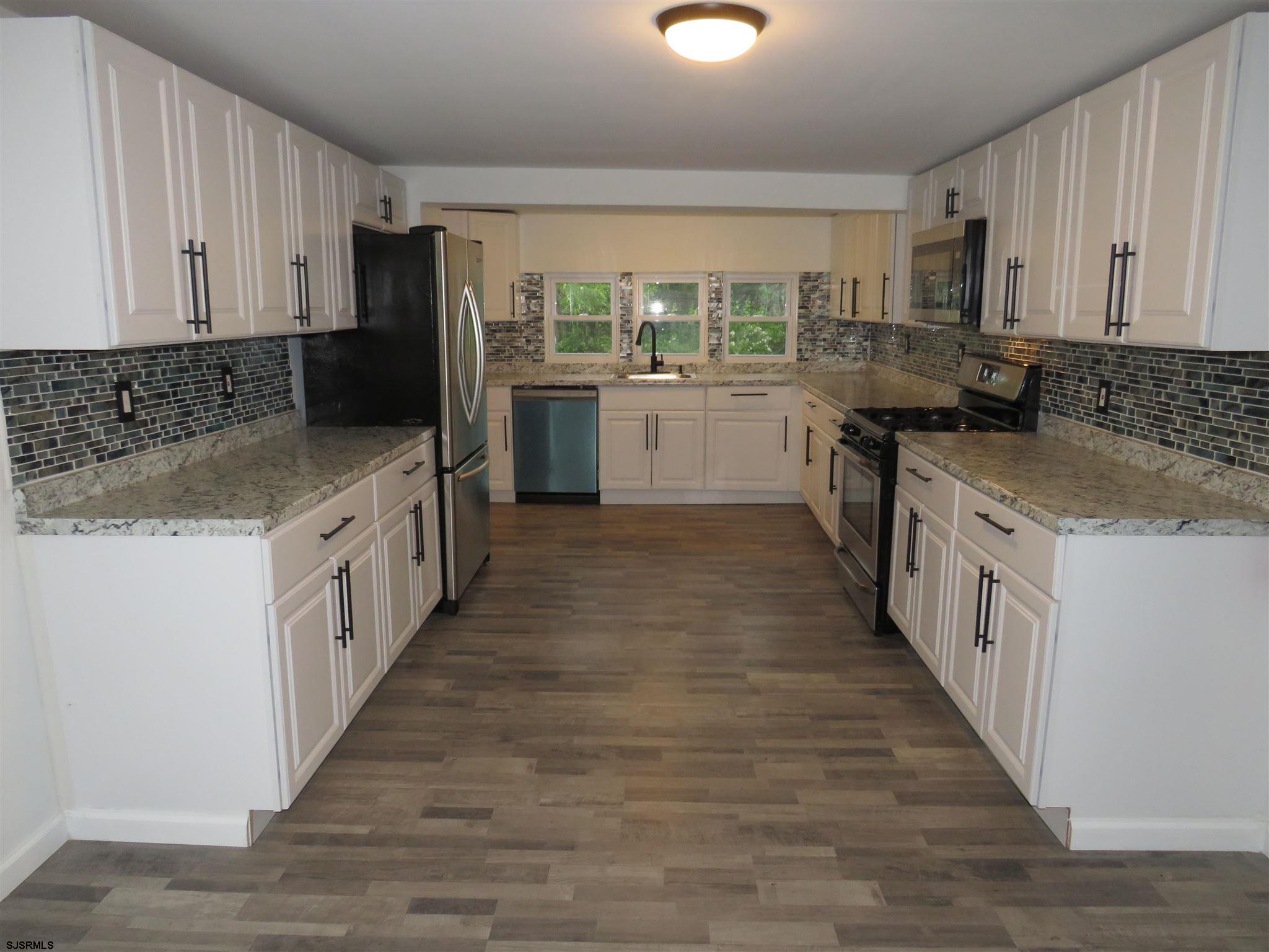 1702 Somers Point Road Egg Harbor Township, NJ 08234 - Photo 9 of 25 a kitchen with stainless steel appliances a sink and a stove top oven